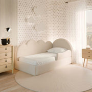 Children's bedroom with a cloud-shaped bed and decorative wall.